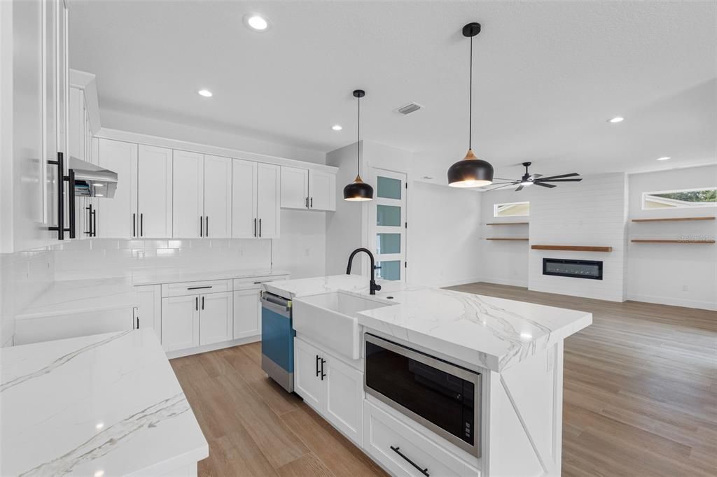 Fireplace, Interior, Kitchen, Pendant Lights, Recessed Lighting, Stainless Steel Appliances, Wood Texture Flooring