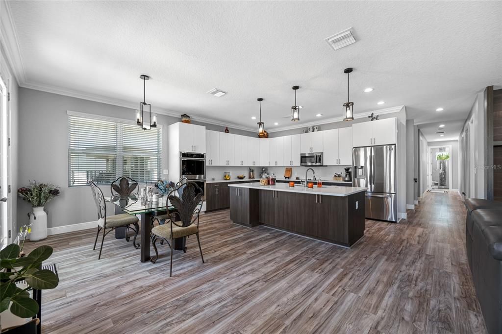 Dining room, Interior, Kitchen, Pendant Lights, Recessed Lighting, Stainless Steel Appliances, Wood Texture Flooring