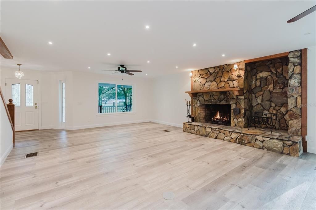 Empty room, Fireplace, Interior, Recessed Lighting, Stone Walls, Wood Texture Flooring