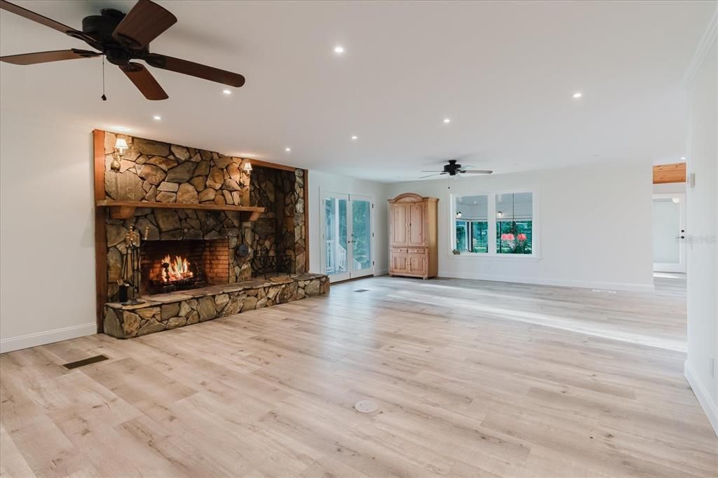 Empty room, Fireplace, Interior, Recessed Lighting, Stone Walls, Wood Texture Flooring