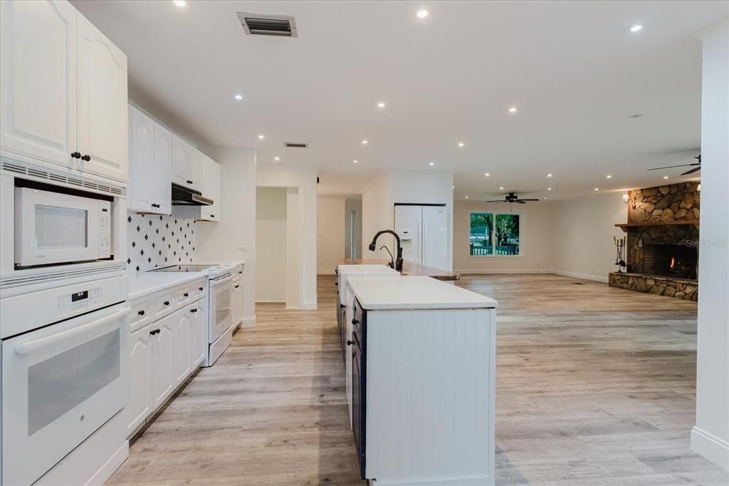 Fireplace, Interior, Kitchen, Recessed Lighting, Stone Walls, Wood Texture Flooring