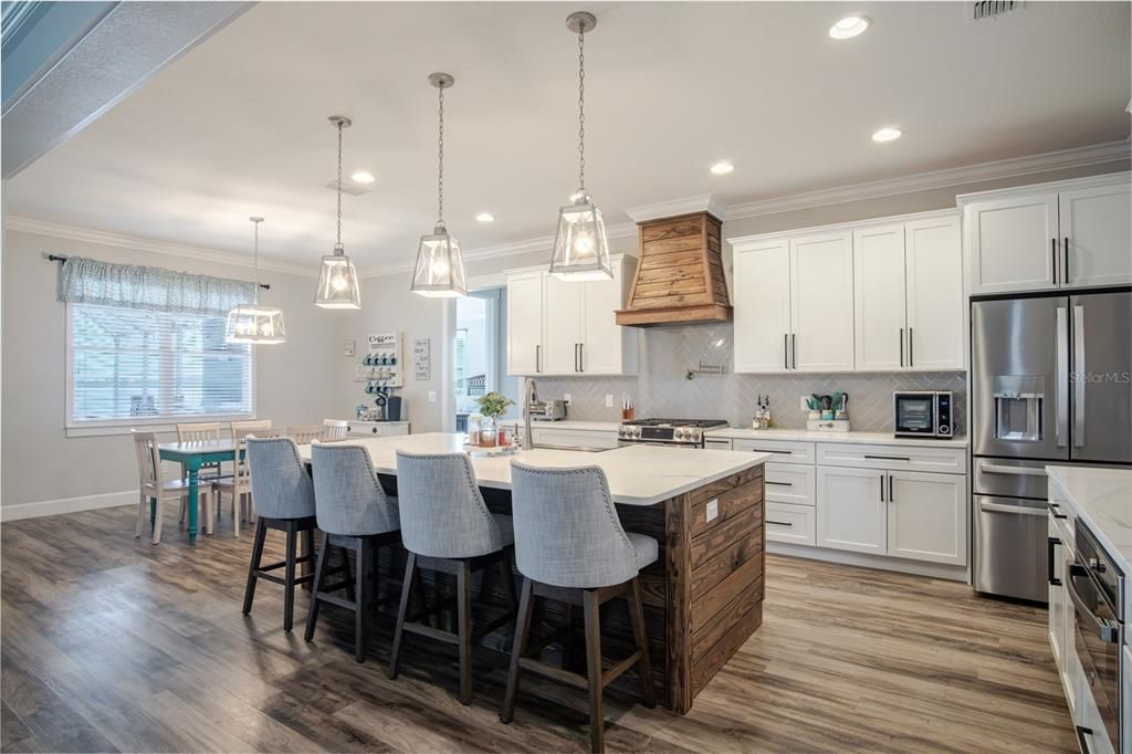 Dining room, Interior, Kitchen, Pendant Lights, Recessed Lighting, Stainless Steel Appliances, Wood Texture Flooring