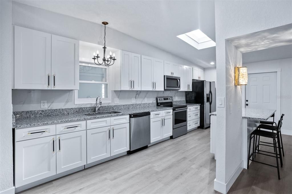 Chandelier, Interior, Kitchen, Pendant Lights, Recessed Lighting, Stainless Steel Appliances, Wood Texture Flooring