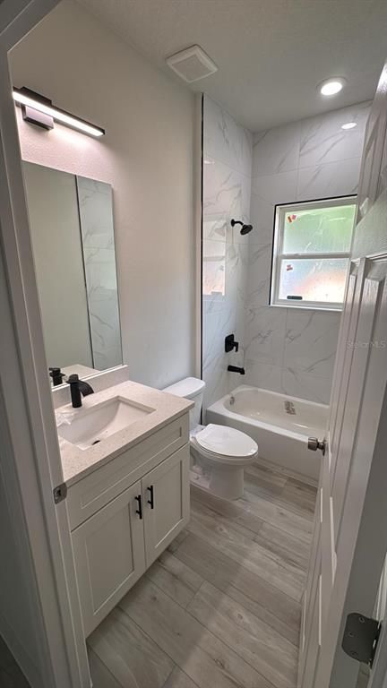 Bathroom, Dual Sink Vanities, Interior, Marble Walls, Recessed Lighting, Wood Texture Flooring