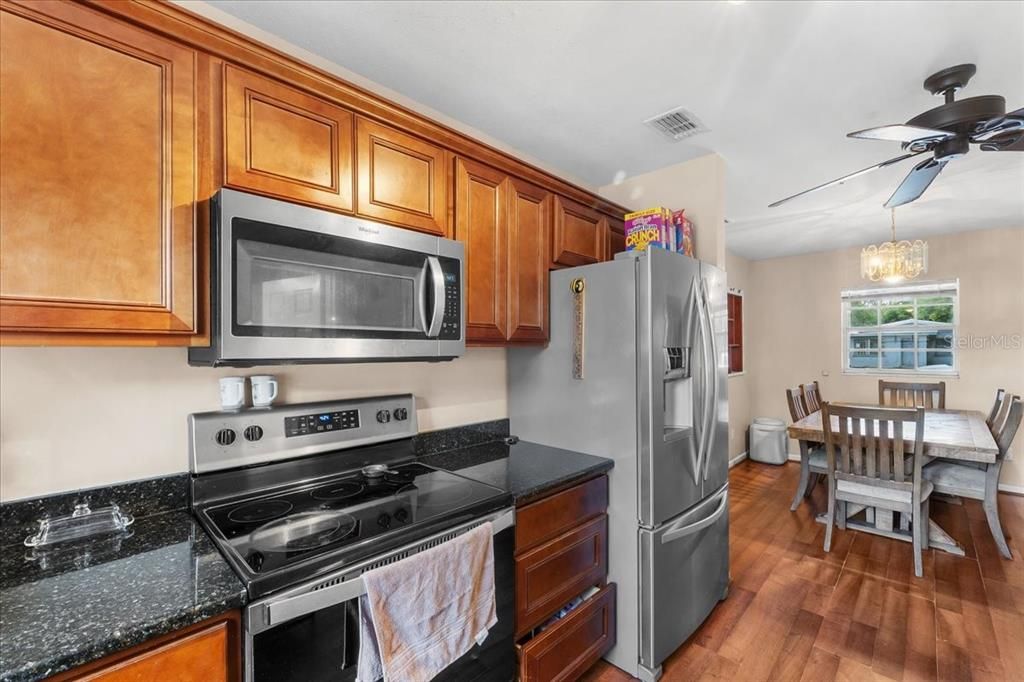 Chandelier, Dining room, Interior, Kitchen, Stainless Steel Appliances, Wood Texture Flooring