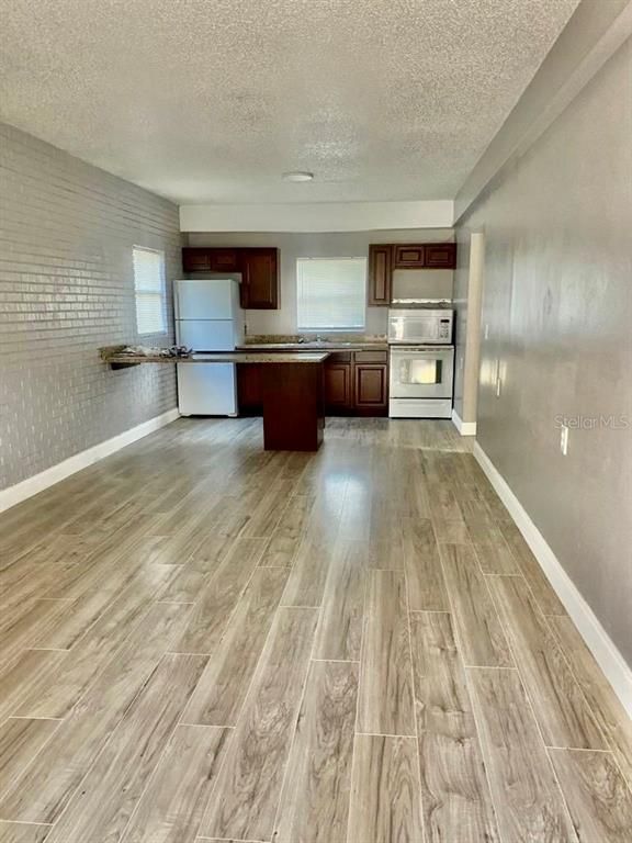 Empty room, Interior, Kitchen, Stainless Steel Appliances, Wood Texture Flooring