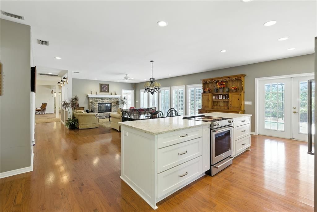 Chandelier, Dining room, Fireplace, Interior, Kitchen, Living room, Recessed Lighting, Wood Texture Flooring
