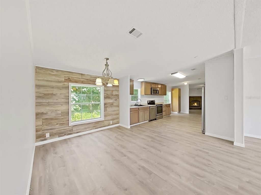 Empty room, Interior, Kitchen, Pendant Lights, Stainless Steel Appliances, Wood Texture Flooring, Wooden Walls