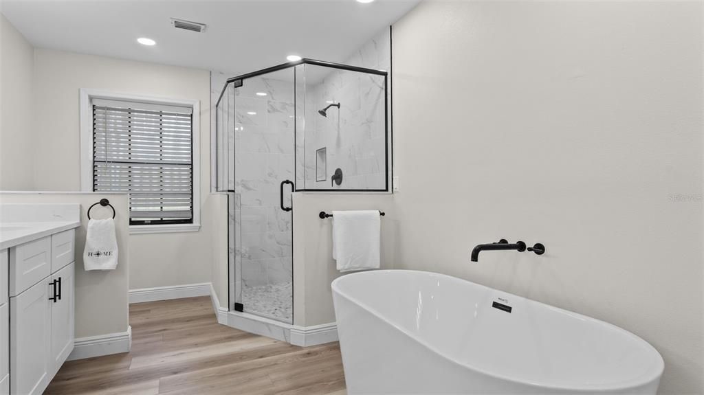 Bathroom, Free Standing Baths, Glass Shower, Interior, Marble Walls, Recessed Lighting, Wood Texture Flooring