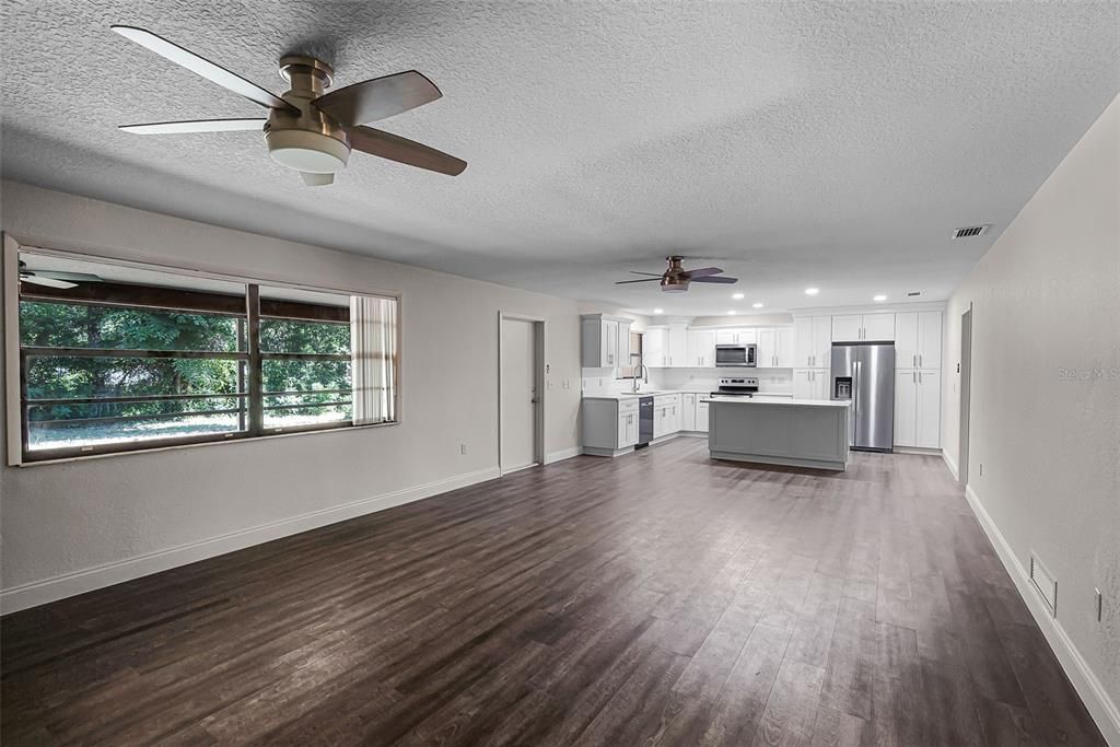 Empty room, Interior, Kitchen, Recessed Lighting, Stainless Steel Appliances, Wood Texture Flooring