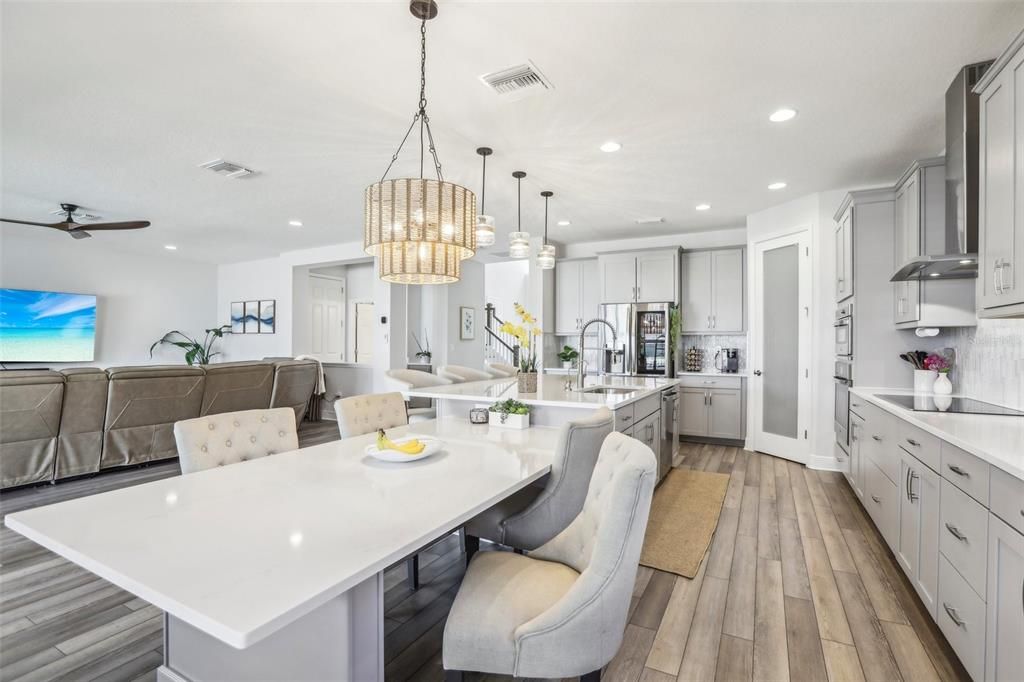 Chandelier, Dining room, Interior, Kitchen, Pendant Lights, Recessed Lighting, Stainless Steel Appliances, Wood Texture Flooring