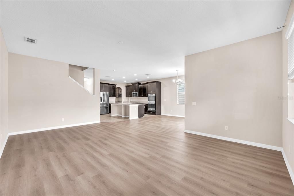 Empty room, Interior, Kitchen, Pendant Lights, Recessed Lighting, Stainless Steel Appliances, Wood Texture Flooring