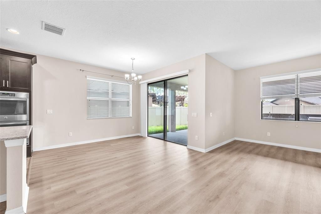 Chandelier, Empty room, Interior, Kitchen, Recessed Lighting, Stainless Steel Appliances, Wood Texture Flooring