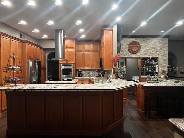 Fireplace, Interior, Kitchen, Recessed Lighting, Stainless Steel Appliances, Stone Walls, Wood Texture Flooring