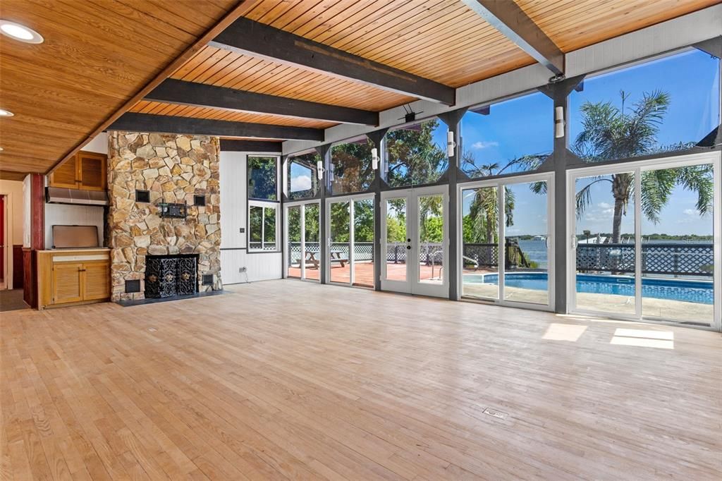 Empty room, Fireplace, Interior, Recessed Lighting, Stone Walls, Sun Room, Water, Wooden Beams, Wooden Ceilings, Wood Texture Flooring