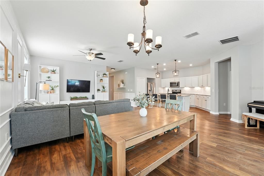 Chandelier, Dining room, Interior, Kitchen, Living room, Pendant Lights, Recessed Lighting, Stainless Steel Appliances, Wood Texture Flooring