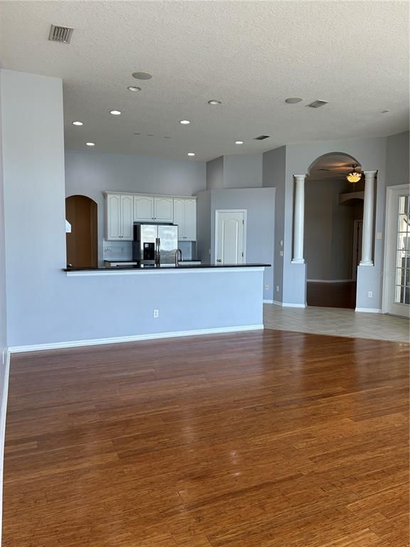 Empty room, Interior, Kitchen, Recessed Lighting, Stainless Steel Appliances, Wood Texture Flooring