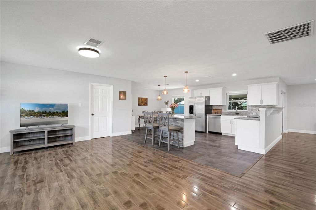Dining room, Interior, Kitchen, Pendant Lights, Recessed Lighting, Stainless Steel Appliances, Wood Texture Flooring