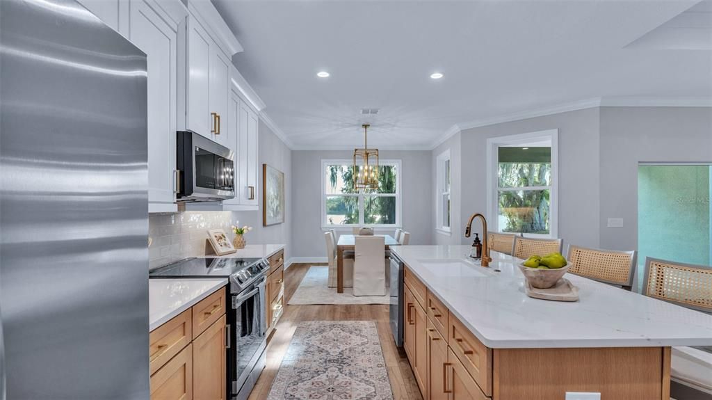 Chandelier, Dining room, Interior, Kitchen, Pendant Lights, Recessed Lighting, Stainless Steel Appliances, Wood Texture Flooring
