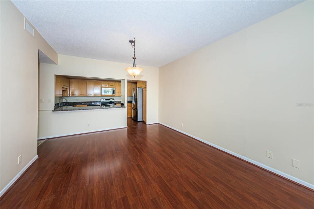 Empty room, Interior, Kitchen, Pendant Lights, Stainless Steel Appliances, Wood Texture Flooring