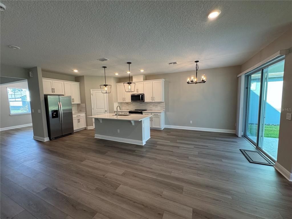 Chandelier, Interior, Kitchen, Pendant Lights, Recessed Lighting, Stainless Steel Appliances, Wood Texture Flooring
