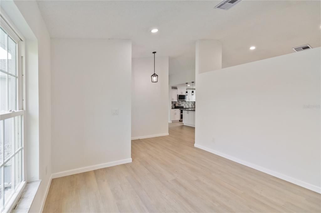 Empty room, Interior, Kitchen, Pendant Lights, Recessed Lighting, Stainless Steel Appliances, Wood Texture Flooring