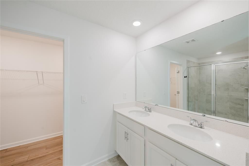 Bathroom, Dual Sink Vanities, Glass Shower, Interior, Recessed Lighting, Walk-in Closets, Wood Texture Flooring