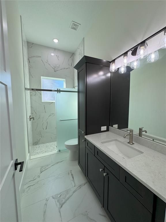Bathroom, Dual Sink Vanities, Glass Shower, Interior, Marble, Marble Walls, Recessed Lighting