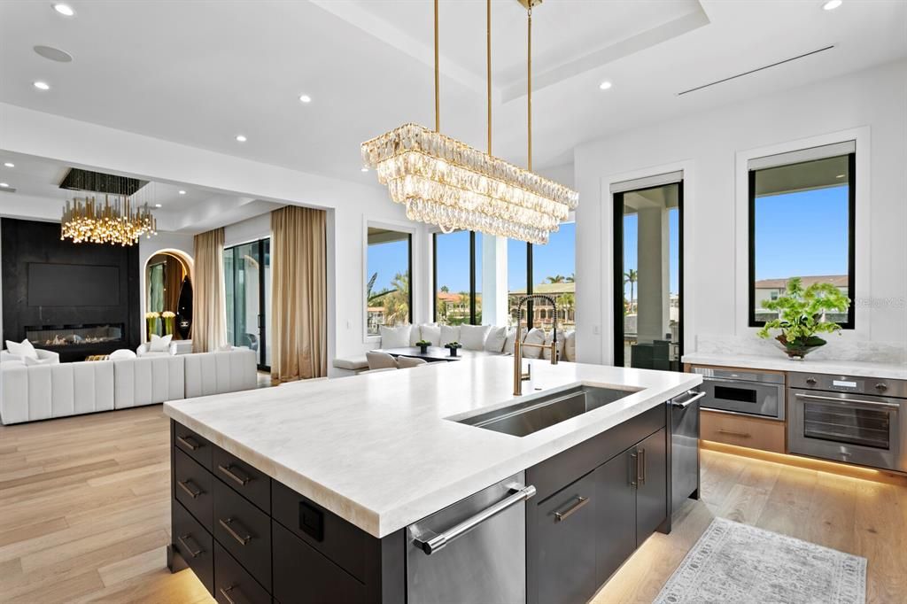 Chandelier, Dining room, Fireplace, Interior, Kitchen, Living room, Recessed Lighting, Stainless Steel Appliances, Wood Texture Flooring