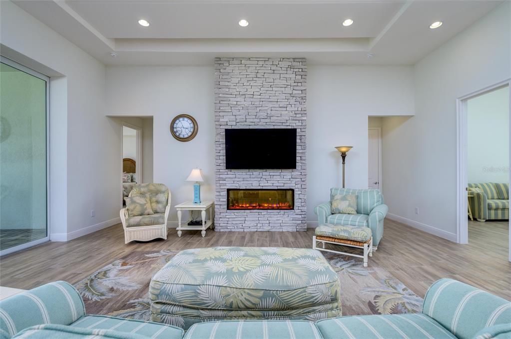 Fireplace, Interior, Living room, Recessed Lighting, Stone Walls, Wood Texture Flooring