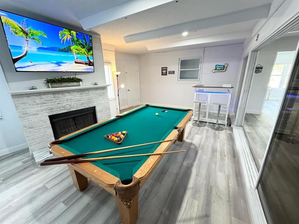 Billiard Table, Fireplace, Game Room, Interior, Recessed Lighting, Stone Walls, Wood Texture Flooring