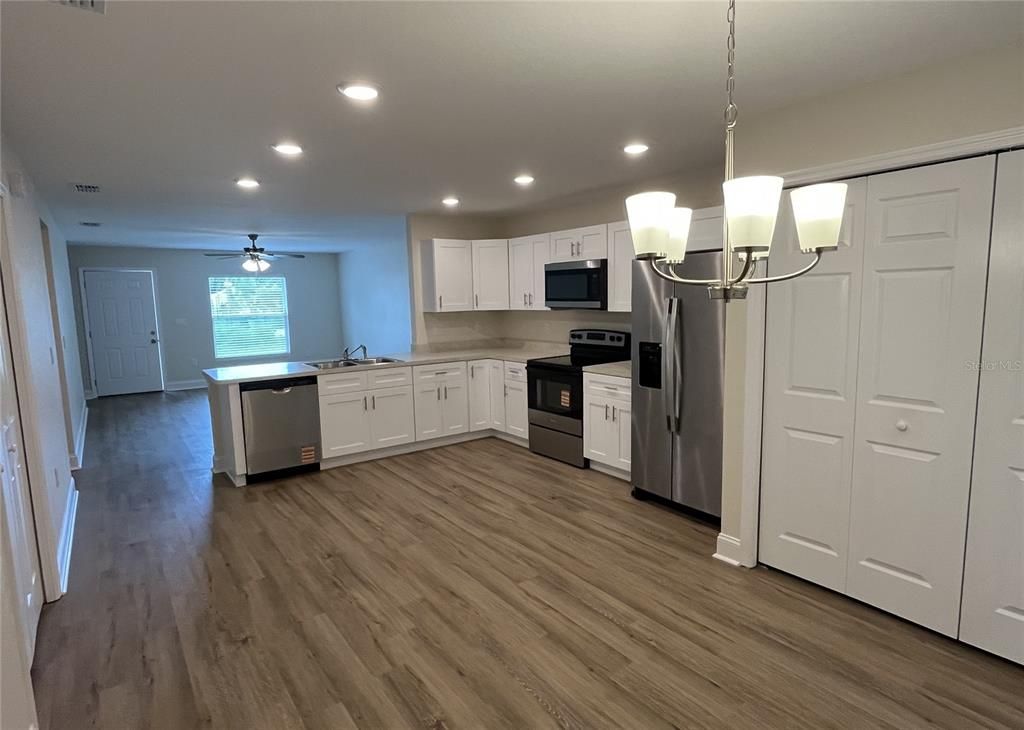 Chandelier, Interior, Kitchen, Recessed Lighting, Stainless Steel Appliances, Wood Texture Flooring