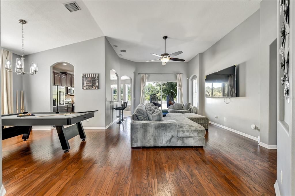 Billiard Table, Chandelier, Game Room, Interior, Living room, Pendant Lights, Recessed Lighting, Wood Texture Flooring