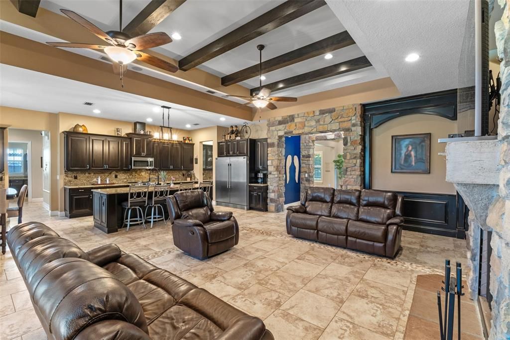 Fireplace, Interior, Kitchen, Living room, Pendant Lights, Recessed Lighting, Stainless Steel Appliances, Stone Walls, Wooden Beams