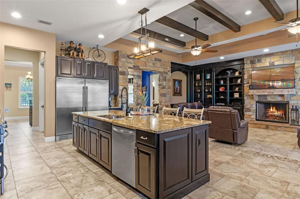 Fireplace, Interior, Kitchen, Living room, Pendant Lights, Recessed Lighting, Stainless Steel Appliances, Stone Walls, Wooden Beams