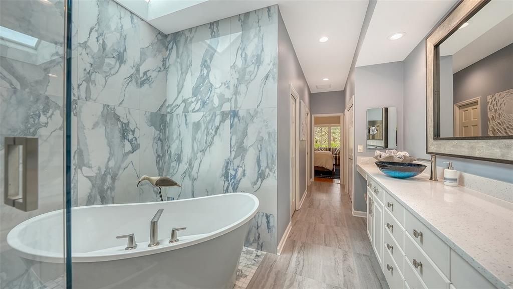 Bathroom, Free Standing Baths, Interior, Marble Walls, Recessed Lighting, Wood Texture Flooring