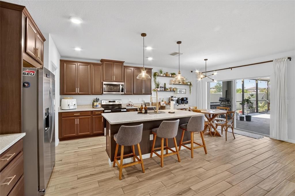 Dining room, Interior, Kitchen, Pendant Lights, Recessed Lighting, Stainless Steel Appliances, Wood Texture Flooring