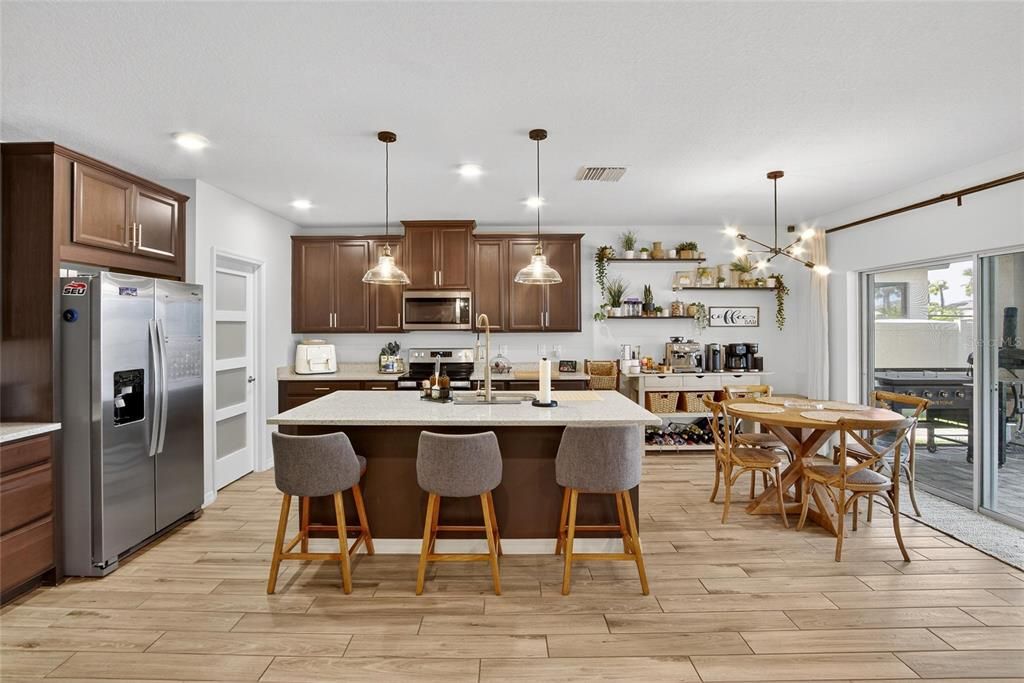 Dining room, Interior, Kitchen, Pendant Lights, Recessed Lighting, Stainless Steel Appliances, Wood Texture Flooring
