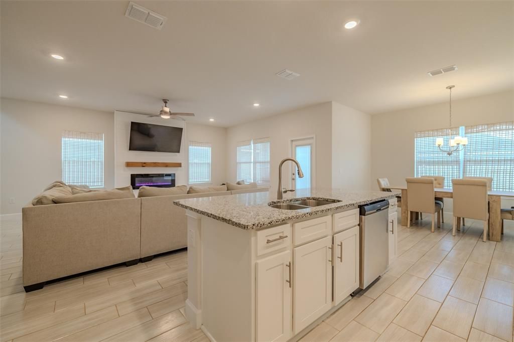 Chandelier, Dining room, Fireplace, Interior, Kitchen, Living room, Recessed Lighting, Wood Texture Flooring