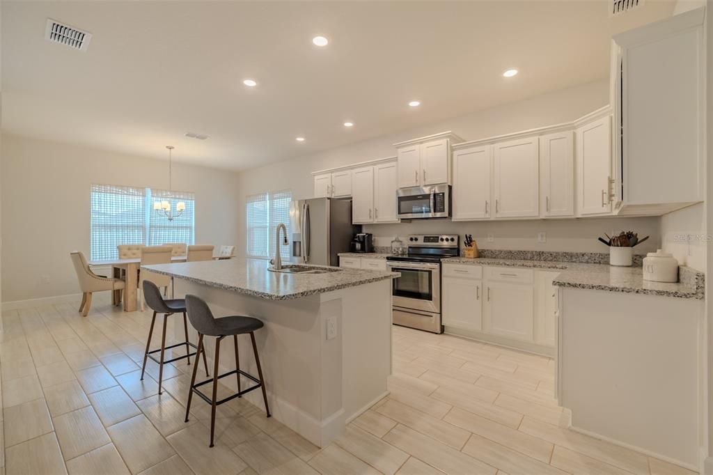 Chandelier, Dining room, Interior, Kitchen, Recessed Lighting, Stainless Steel Appliances, Wood Texture Flooring
