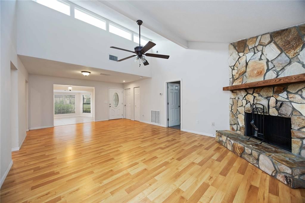 Empty room, Fireplace, Interior, Recessed Lighting, Stone Walls, Wood Texture Flooring