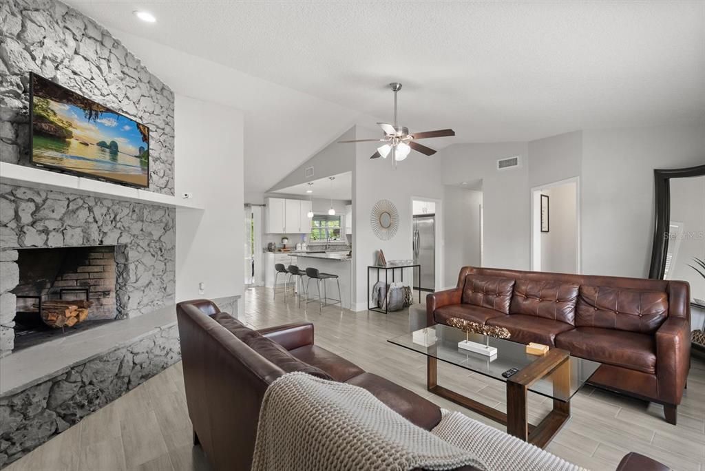 Fireplace, Interior, Living room, Recessed Lighting, Stone Walls, Wood Texture Flooring