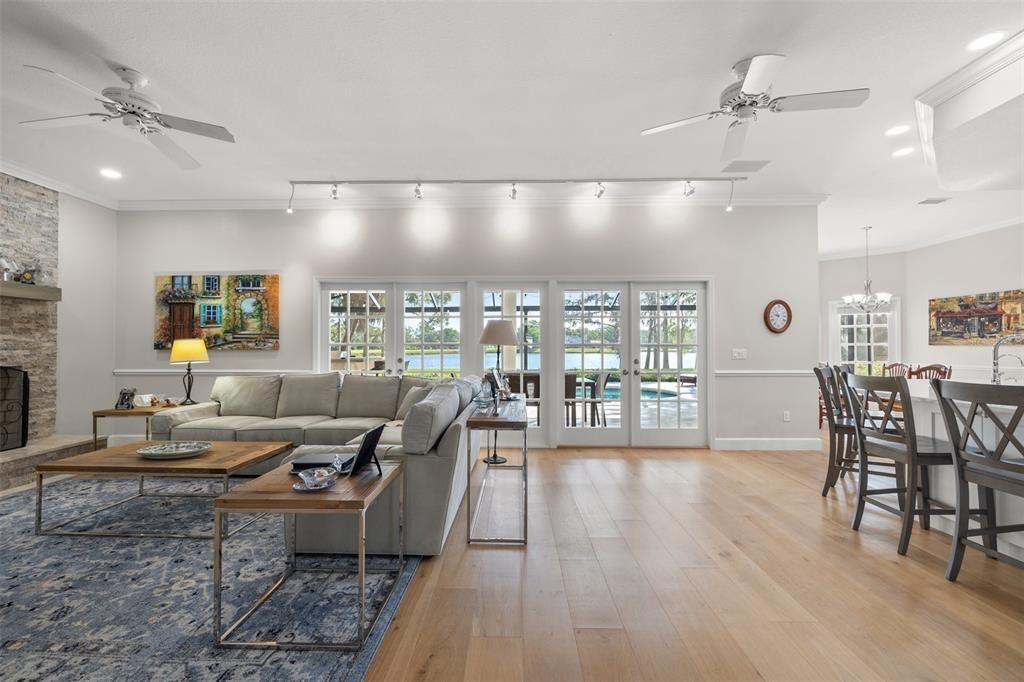 Dining room, Fireplace, Interior, Living room, Recessed Lighting, Stone Walls, Wood Texture Flooring