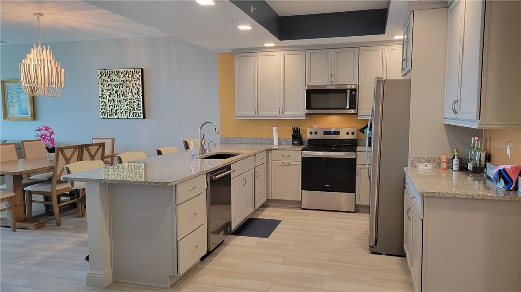 Chandelier, Dining room, Interior, Kitchen, Pendant Lights, Recessed Lighting, Stainless Steel Appliances, Wood Texture Flooring