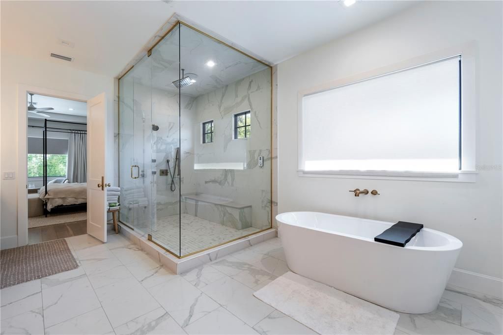 Bathroom, Free Standing Baths, Glass Shower, Interior, Marble, Marble Walls, Recessed Lighting, Wood Texture Flooring