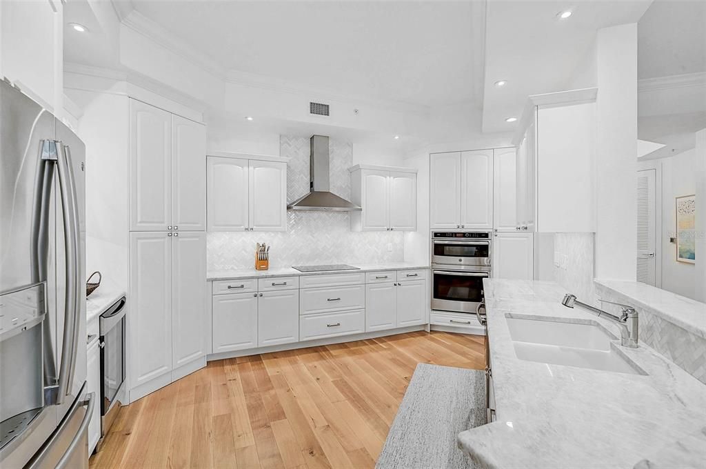 Interior, Kitchen, Marble Walls, Recessed Lighting, Stainless Steel Appliances, Wood Texture Flooring