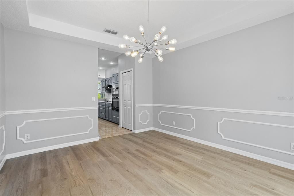 Empty room, Interior, Kitchen, Pendant Lights, Recessed Lighting, Stainless Steel Appliances, Wood Texture Flooring
