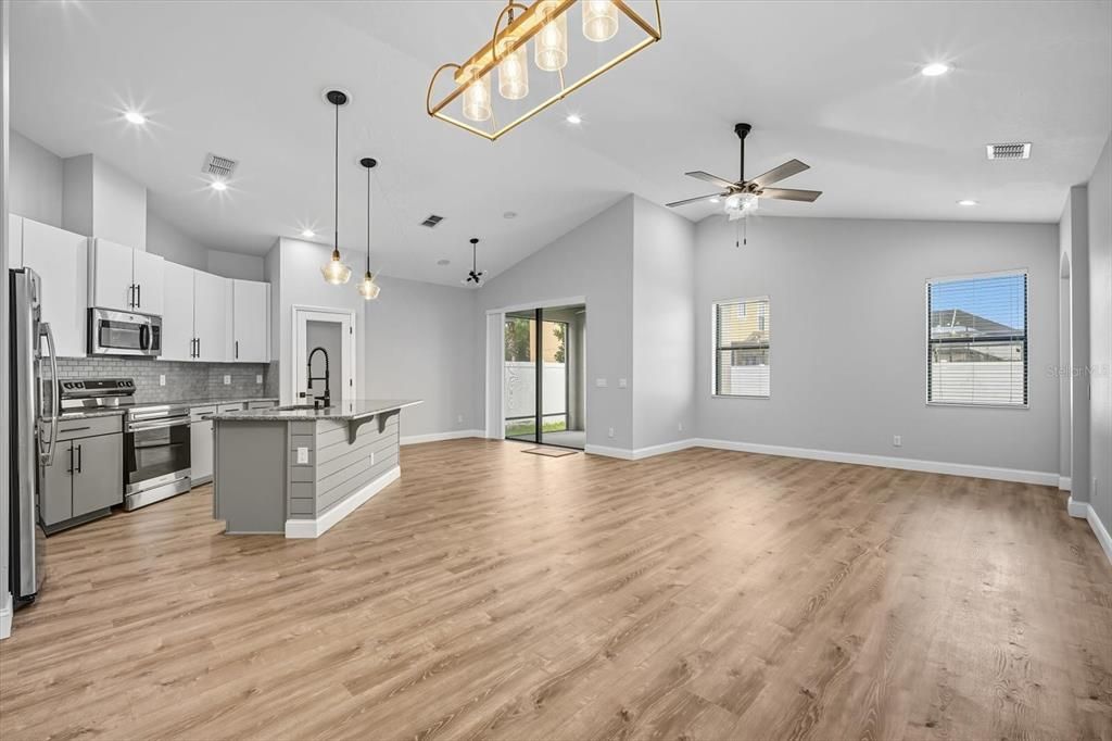 Empty room, Interior, Kitchen, Pendant Lights, Recessed Lighting, Stainless Steel Appliances, Wood Texture Flooring