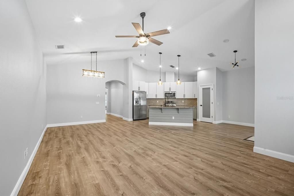 Empty room, Interior, Kitchen, Pendant Lights, Recessed Lighting, Stainless Steel Appliances, Wood Texture Flooring
