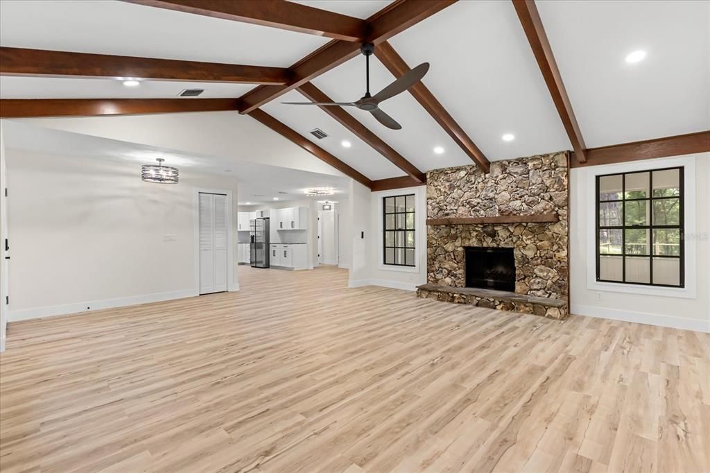 Empty room, Fireplace, Interior, Recessed Lighting, Stone Walls, Wooden Beams, Wood Texture Flooring